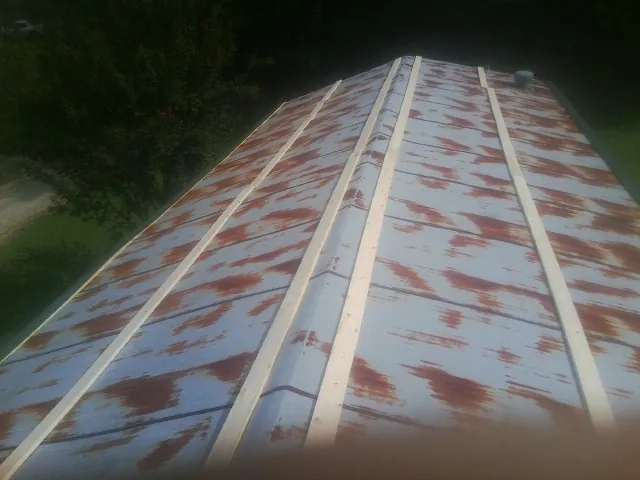 Rusted metal roof panels with new wood purlins before replacement — Storm Damage Roof Repair in Medfield by Roofing Brothers